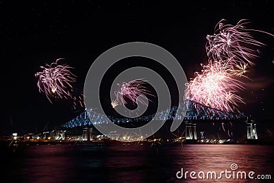 Colorful fireworks explode over bridge. Montrealâ€™s 375th anniversary. luminous colorful interactive Jacques C Stock Photo